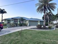 Charming single-story home with a well-manicured lawn, mature landscaping, and a spacious three-car garage at 399 Bal Harbor Blvd, Punta Gorda, FL 33950