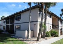 Condo building with a well-maintained exterior and tropical landscaping at 19505 Quesada Ave # Mm202, Port Charlotte, FL 33948