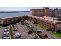 Exterior view of multi-story condo building with parking area and waterfront access at 5020 Brittany S Dr # 324, St Petersburg, FL 33715