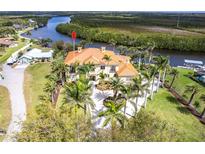 Stunning waterfront estate with lush landscaping, circular driveway, and panoramic views of the river at 7440 Riverside Dr, Punta Gorda, FL 33982