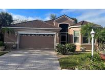 Charming single-story home with lush landscaping and a two-car garage with a stone paver driveway at 10488 Princess Ct, Punta Gorda, FL 33955