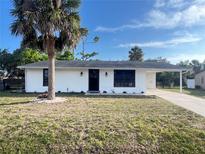 Charming single-story home with a well-maintained lawn and a classic white exterior at 2507 Linton Ln, Port Charlotte, FL 33952