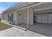 Charming single-story home featuring a covered carport and a cozy front porch entrance at 3627 Easy St, Port Charlotte, FL 33952