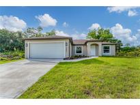 Charming single-story home with a well-manicured lawn and inviting curb appeal at 3841 Cinderella Rd, North Port, FL 34286