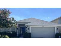 Charming single-story home featuring a well-manicured lawn, attached two-car garage, and a welcoming front entrance at 10052 Winding River Rd, Punta Gorda, FL 33950