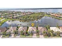 An attractive waterfront home with a screened lanai and a tile roof, nestled in a tranquil neighborhood at 13096 N Marsh Dr, Port Charlotte, FL 33953