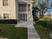 Inviting condo exterior with well-maintained landscaping and a pathway to the entrance at 1340 San Cristobal Ave # 207, Punta Gorda, FL 33983