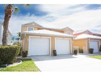 Inviting two-story exterior with a two-car garage, and a lush green lawn adding curb appeal to this charming home at 2002 Bal Harbor Blvd # 311, Punta Gorda, FL 33950