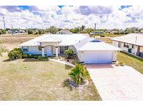 Charming single-story home with a white metal roof, a two-car garage, and a well-maintained front yard at 3160 Highlands Rd, Punta Gorda, FL 33983