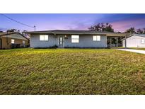 Charming single-story home with a well-maintained lawn and inviting curb appeal, perfect for families at 5211 Prime Ter, North Port, FL 34286