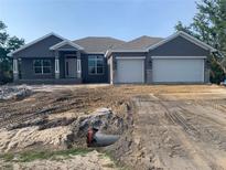 New home features a two-car garage, modern elevation, and well-lit entryway at 14583 Lillian Cir, Port Charlotte, FL 33981