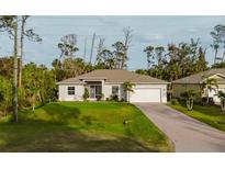 Charming single-story home with a well-manicured lawn, attached garage, and inviting curb appeal at 1470 Atwater Dr, North Port, FL 34288