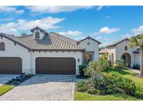 A charming single-story home with a tile roof, well-manicured lawn, and a two-car garage, perfect for a Gathering at 27500 Janzen Ct, Englewood, FL 34223