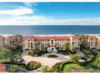 Beautiful exterior shot of a multi-story condominium building with well-manicured landscaping and water views at 87 Vivante Blvd # 8732, Punta Gorda, FL 33950