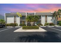 Well-maintained condo building featuring lush landscaping and convenient parking at 1423 Mediterranean Dr # C, Punta Gorda, FL 33950