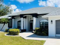 Charming single-Gathering home with a well-manicured lawn and attractive architectural details at 26102 Ancuda Dr, Punta Gorda, FL 33983