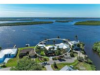 Expansive waterfront home boasts mature landscaping, private docks, and stunning views of the surrounding waterways at 3790 Peace River Dr, Punta Gorda, FL 33983