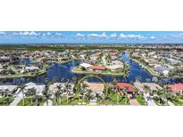 Aerial view of waterfront homes showcasing backyard canals and landscaping in tropical community at 494 Monaco Dr, Punta Gorda, FL 33950