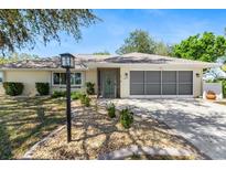 Charming one-story home with manicured front yard and attached two-car garage at 1489 Kedron Ln, Punta Gorda, FL 33983