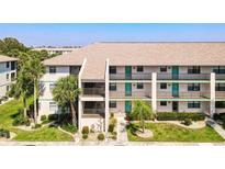 Condominium building showcasing a well-maintained facade, lush landscaping, and a welcoming entrance at 175 Kings Hwy # 232, Punta Gorda, FL 33983