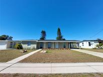 Charming single-story home featuring a well-maintained lawn and covered parking area at 4045 Conway Blvd, Port Charlotte, FL 33952