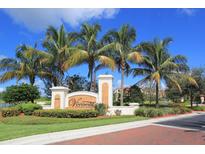 Inviting community entrance with palm trees and attractive landscaping at 99 Vivante Blvd # 404, Punta Gorda, FL 33950