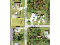 An aerial view showcases neighborhood with clearly marked parcel lines and property boundaries at 1027 Campbell St, Port Charlotte, FL 33953