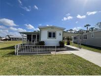 Charming single-story home with carport, screen door, and well-maintained lawn under a sunny sky at 6830 Pleasant Ct, North Port, FL 34287