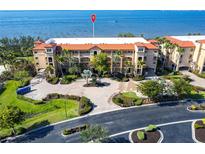 Beautiful condo building featuring lush landscaping and water views at 93 Vivante Blvd # 9323, Punta Gorda, FL 33950