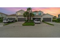 Charming two-story townhouse with attached garages and well-manicured landscaping at sunset at 14049 Black Beauty Dr # 721, Punta Gorda, FL 33955