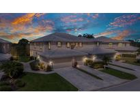Beautifully landscaped townhome with tile roof, two-car garage and neutral exterior paint at 3393 Grand Vista Ct # 101, Port Charlotte, FL 33953