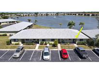 Inviting condo complex offering a picturesque view of the serene lake and lush landscaping in a convenient community at 25225 Rampart Blvd # 604, Punta Gorda, FL 33983
