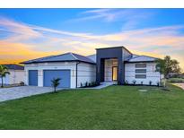 Beautiful home with modern architecture, well-manicured lawn, and a two-car garage in a lovely neighborhood at 9493 St Paul Dr, Port Charlotte, FL 33981