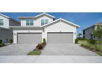 Charming two-story home with two-car garage and well-maintained driveway and manicured landscaping at 15951 Grassland Ln # 3812, Punta Gorda, FL 33982