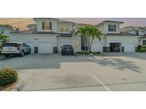 Inviting townhouse with two-car garage, lush landscaping, and ample parking, perfect for comfortable living at 17288 Acapulco Rd # 411, Punta Gorda, FL 33955