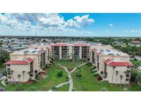 Beautiful aerial view of a condo complex with manicured landscaping and nearby city amenities at 3006 Caring Way # 329, Port Charlotte, FL 33952