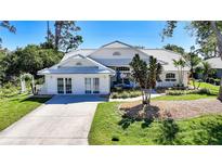 Charming single-Gathering home with a white tiled roof, well-manicured lawn, and inviting curb appeal at 388 Wabash Ter, Port Charlotte, FL 33954