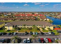 Beautiful aerial view of condo community with lush landscaping and canal access at 4000 Bal Harbor Blvd # 217, Punta Gorda, FL 33950