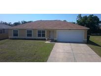 Charming single-story home with a well-manicured lawn and a two-car garage at 4237 Irdell Ter, North Port, FL 34288