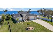 Stunning waterfront home with lush landscaping, three car garage and beautiful water views at 4450 Northshore Dr, Punta Gorda, FL 33980