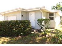 Charming single-story home features a well-manicured front yard, a white front door, and a light-colored exterior at 503 Myrtle St, Punta Gorda, FL 33950