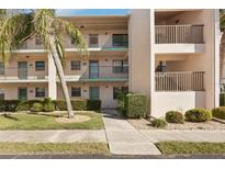 Attractive condo building featuring a lush, green landscaped yard and a well-maintained walkway leading to the entrance at 175 Kings Hwy # 717, Punta Gorda, FL 33983