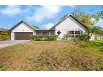 Charming single-story home with a well-maintained lawn and an attached garage at 2027 59Th N St, Clearwater, FL 33760