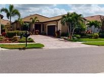 Beautiful single-story home with a well-manicured lawn and lush landscaping at 2436 Arugula Dr, North Port, FL 34289