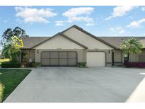 Charming single-story villa with attached two-car garage, neutral paint and manicured landscaping at 26169 Explorer Rd # 7P, Punta Gorda, FL 33983