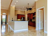 An open-concept kitchen featuring wooden cabinetry, granite countertops, and stainless steel appliances at 3812 Carupano Ct, Punta Gorda, FL 33950