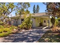 Charming single-story home with lush landscaping and a welcoming front entrance, perfect for serene living at 1060 Venetian Pkwy, Venice, FL 34285