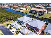 Stunning aerial view of waterfront property with boat docks, complemented by lush landscaping and serene surroundings at 2002 Bal Harbor Blvd # 1022, Punta Gorda, FL 33950