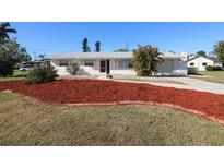 Charming single-story home with landscaped front yard and well-maintained lawn at 22191 New Rochelle Ave, Port Charlotte, FL 33952