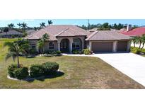 Beautiful single-story home featuring a tile roof, a spacious front lawn, and a two-car garage at 569 Royal Poinciana, Punta Gorda, FL 33955